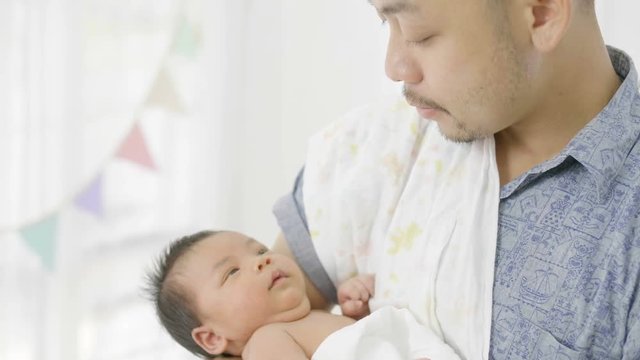 4K Slow motion Happy Asian father take care his newborn baby, Tilt up shot