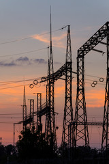 High voltage power plant at sunset