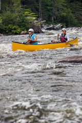 Group of people paddling the whitewater of the Noire River in Quebec, Canada.