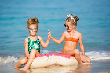 Happy girls on the sea. Cheerful girlfriends playing around on vacation. © viclin