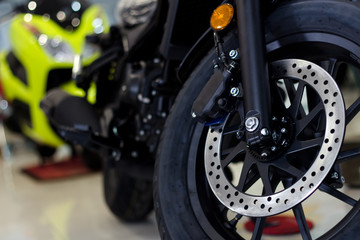 closeup tire and dish bake of  sport motorcycle ( big bike ) with soft-focus in the background and over light