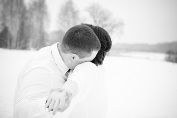 Happy Couple in Winter Park with romantic mood .Family Outdoors. love at 14 february, outdoor fashion portrait of sensual couple in cold winter weather. lovers and kisses 