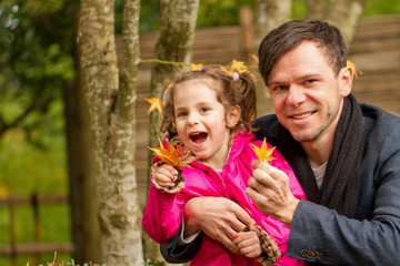 Happy family Father and Cute Little Toddler Daughter on a walk in the Autumn Leaf Fall in Park Portland Oregon USA