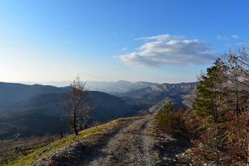 Narrow high path on dry rocky mountain. Beautiful scenery landscape.