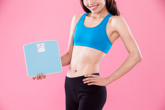 sport woman take weight scale