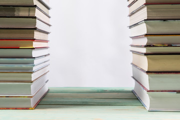 Pile of various books on wooden background