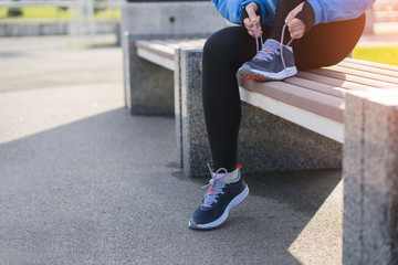 The Runner woman ties the shoelaces before running. Healthy lifestyle.