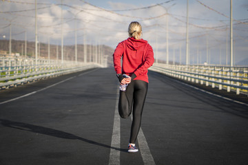 Runner stretching  on the road in the Park. Healthy lifestyle.