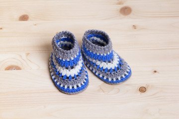 Baby Booties Crochet on wooden background