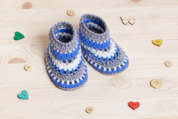 Baby Booties Crochet on wooden background