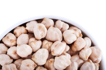 Raw dry chickpeas in bowl on white background