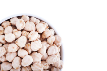 Raw dry chickpeas in bowl on white background