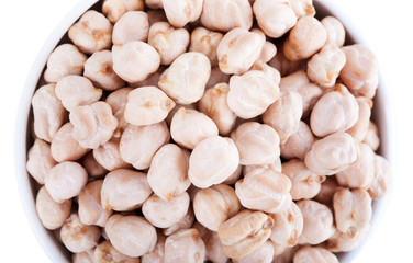 Raw dry chickpeas in bowl on white background