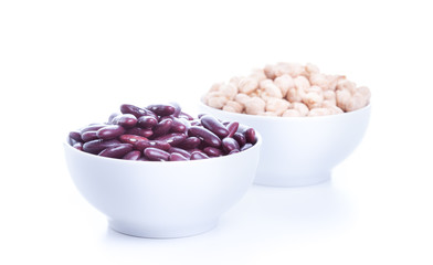 Raw dry chickpeas and red beans in bowl on white background