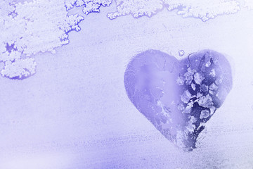 Heart shape symbol on Frozen window glass