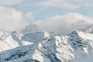 Fototapeta na wymiar Snow-capped peaks of the Caucasus Mountains. Caucasian landscape