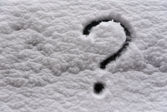 Snow texture with question mark. Picture on the snow surface.