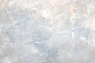 texture of the surface of an old antique wall with a plaster layer destroyed from moisture, a lot of cracks, irregularities, blisters on the wall, abstract background