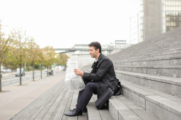 effect. Tutor dressed in gray coat sitting on rung and read morning newspaper. Articles pleased man...