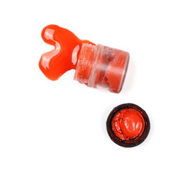 Fototapeta premium Spilled red watercolor with bottle isolated on white background, top view