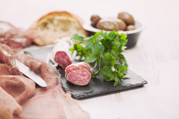 Traditional Spanish sausage Fuet on black ceramic background