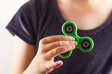 Girl to play with Fidget Spinner in his hands