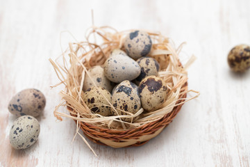 Naklejka na ściany i meble quail eggs in small dish on wooden background