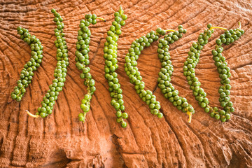 Fresh Peppercorn on old wooden background