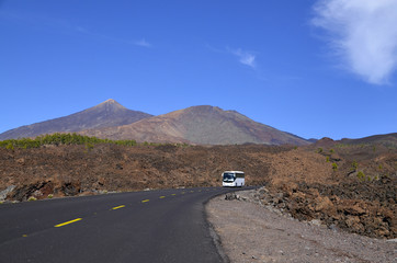 Road towards volcano El Teide with tourist bus driving through Teide National Park,Tenerife.Mount Teide is the Canary Islands most visited tourist attraction.