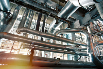 Fototapeta premium Industrial Steel pipelines, valves, cables and walkways
