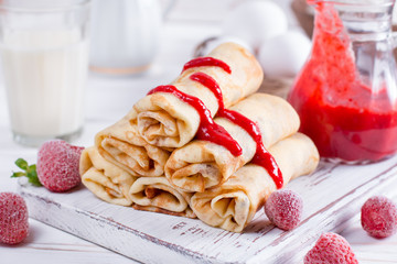 Pancakes stuffed with cottage cheese and berry sauce