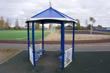 Wooden gazebo recreation area and children playground at seaside public park. Wooden pergola...