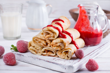 Pancakes stuffed with cottage cheese and berry sauce