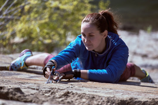 The Girl Is Climbing A Complex Rocky Terrain.