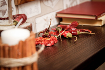 Chili Peppers. Vintage Style. Old Fashion Kitchen Shelf Background with Old Books. toned.