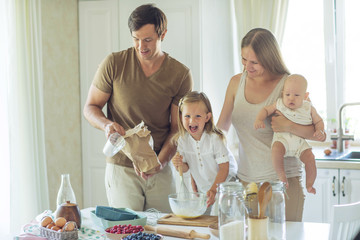 The family cooks in the kitchen 
