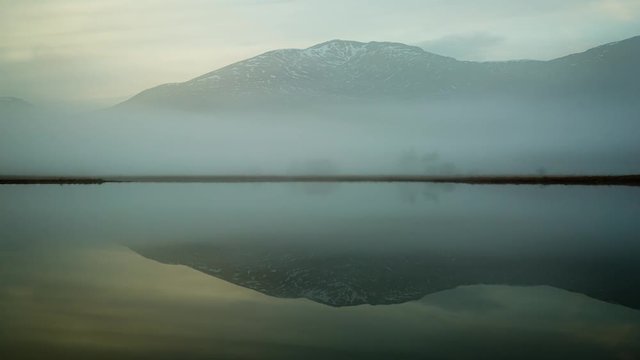 fog moving over loch tulla in the remote highlands of scotland during winter