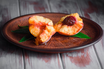 Ripe peaches on a table with tasty honey