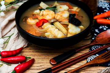 Bowls of Asian soup noodles and vegetables with Chopstick