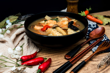 Bowls of Asian soup noodles and vegetables with Chopstick