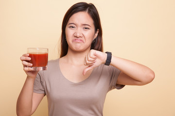 Asian woman thumbs down  hate tomato juice.