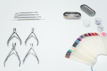 Tools аor manicure, tongs, palette. White background.