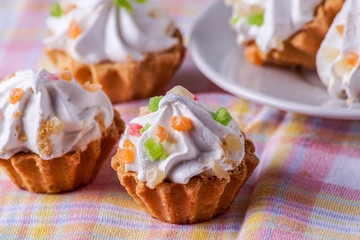 Delicious homemade cupcakes with cream, on a plate.