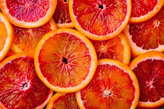 Background made of ripe juicy blood orange slices.