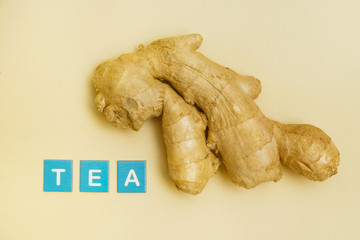 Fresh ginger root on yellow background