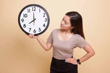 Young Asian woman with a clock.