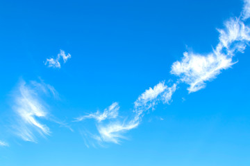 blue sky background with tiny clouds.