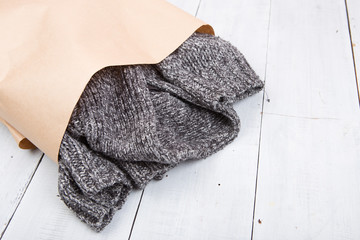 knitted winter sweater on wooden background