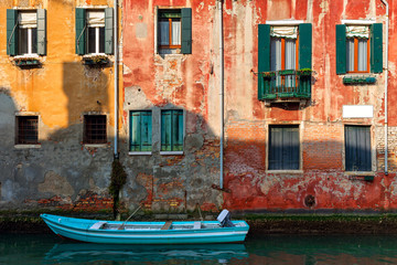 Fototapeta na wymiar Old house and boat on canal in Venice, Italy.