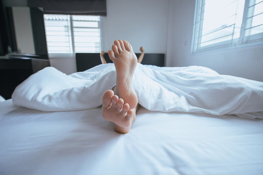 Close up of  barefoot,Feet and stretch lazily on the bed after waking up